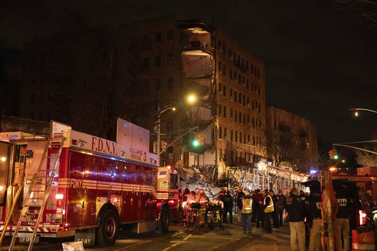 YUKI IWAMURA/AP
                                First responders work at the scene of a collapsed building in the Bronx borough of New York.