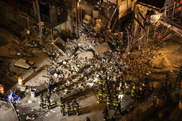 YUKI IWAMURA/AP
                                First responders work at the scene of a collapsed building in the Bronx borough of New York.