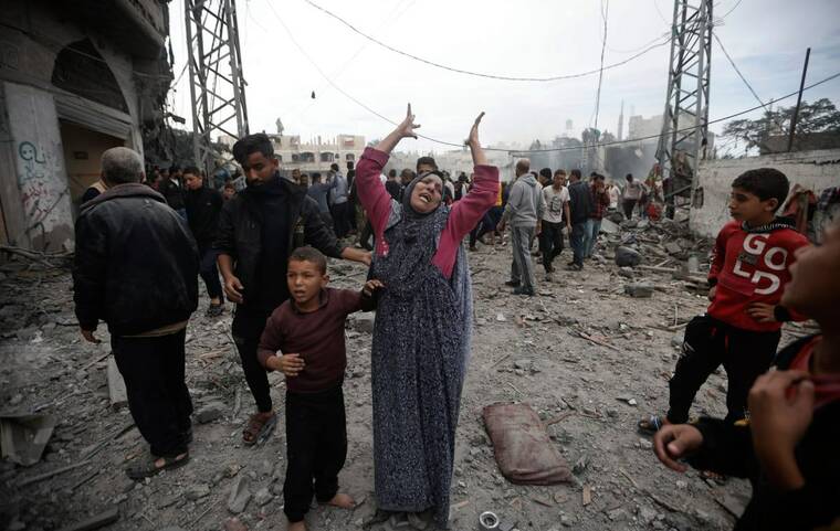 ASSOCIATED PRESS
                                A Palestinian woman gestures following Israeli airstrikes in Khan Younis refugee camp, southern Gaza Strip, today.