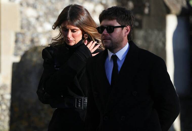 REUTERS/TOBY MELVILLE
                                Niall Horan and Amelia Woolley depart after the funeral of former One Direction singer Liam Payne at St. Mary’s Church in Amersham, near London, on Wednesday.