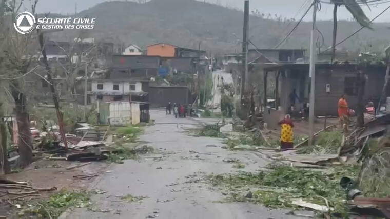 FRENCH CIVIL SECURITY/HANDOUT VIA REUTERS
                                Locals stand on a street covered in debris after Cyclone Chido swept through Mayotte, France in this screengrab taken from a handout video obtained by Reuters.