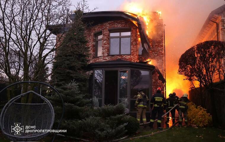 REUTERS/HANDOUT
                                Firefighters work at the site of a Russian missile strike in Dnipro, Ukraine, today.