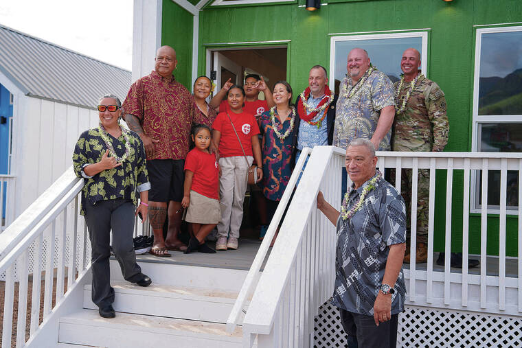 FEDERAL EMERGENCY MANAGEMENT AGENCY
                                Officials gathered Friday with the Folaumoeloa family outside their new home.