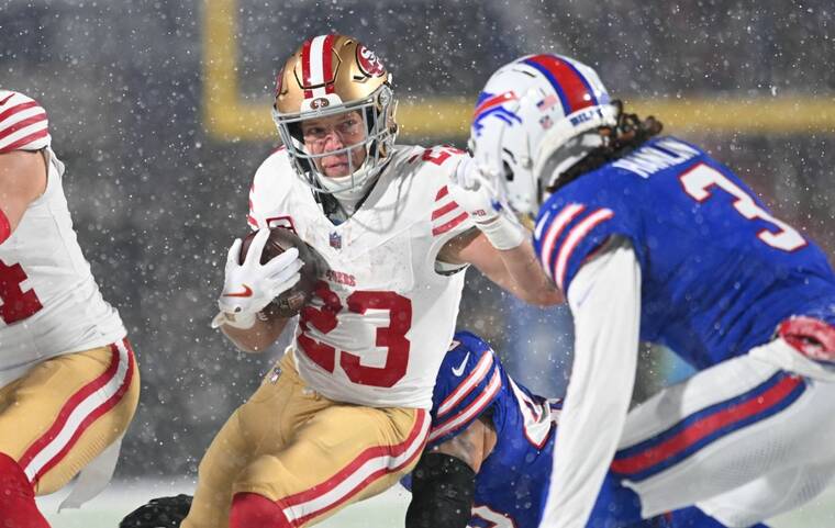 MARK KONEZNY-IMAGN IMAGES/ FILE PHOTO
                                San Francisco 49ers running back Christian McCaffrey tries to avoid Buffalo Bills safety Damar Hamlin, Sunday, on a run in the first quarter at Highmark Stadium.