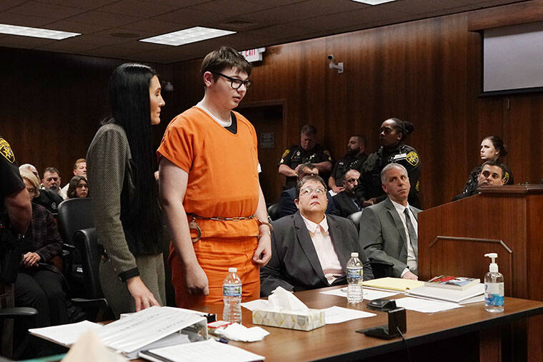 CARLOS OSORIO / AP
                                Ethan Crumbly stands and addresses the court before being sentenced, Friday, Dec. 8, in Pontiac, Mich. Crumbly sentenced to life in prison for killing four students, wounding more and terrorizing Michigan’s Oxford High School in 2021. A judge Friday rejected pleas for a shorter sentence and ensured that Crumbley, 17, will not get an opportunity for parole.