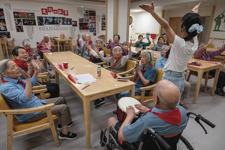 NEW YORK TIMES
                                Zhang Youlan, a former kindergarten teacher, leads a singing class at a nursing home in Xi’an, in central China.