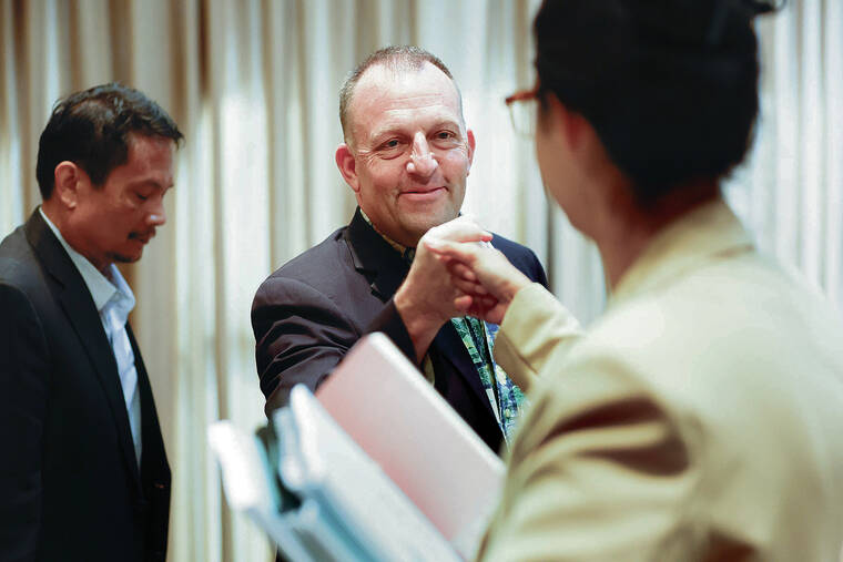 GEORGE F. LEE / GLEE@STARADVERTISER.COM
                                Gov. Josh Green gave a fist bump to a member of his policy team in the ceremonial room at the state Capitol shortly before his presentation of the biennium budget.