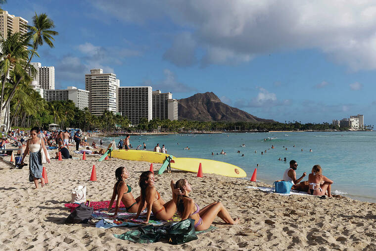 CINDY ELLEN RUSSELL / CRUSSELL@STARADVERTISER.COM
                                Those in the tourism industry say overall numbers across Hawaii since the pandemic and wildfires are showing some improvement but that the recovery is slower than anticipated. At top, visitors enjoyed a day at the beach Thursday.