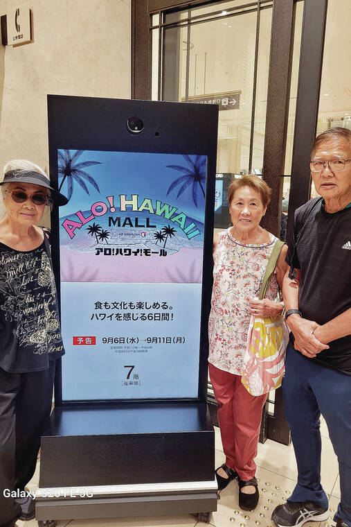 Helene Nakamoto of Honolulu, and friends Andrea and Al Shimokawa, were enjoying a trip to Sapporo, Japan, when they saw a poster promoting Alo! Hawaii Mall. Photo by Harry Nakamoto.