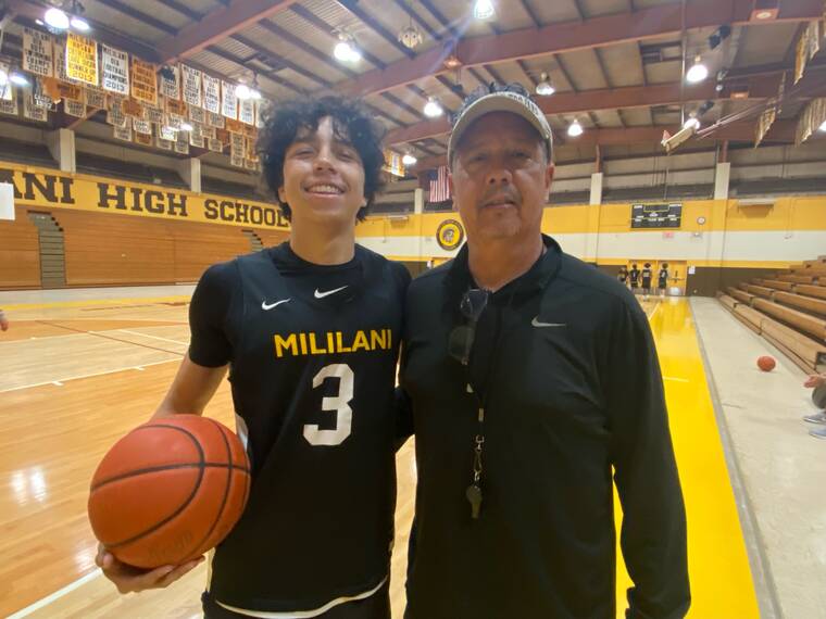 PAUL HONDA / PHONDA@STARADVERTISER.COM
                                Mililani’s 6-foot-3 standout Roman Gabriel posed with his father and Trojans coach Garrett Gabriel at Mililani gym on Monday.